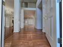 Spacious foyer with gleaming hardwood floors, elegant staircase, and abundant natural light at 3773 Summer Rose Dr, Atlanta, GA 30341