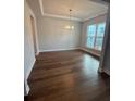 Elegant dining room with hardwood floors, tray ceiling, and bright windows at 4297 Azalea Ridge Way, Hoschton, GA 30548