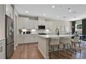 Spacious kitchen with stainless steel appliances, quartz countertops, large island, and hardwood flooring at 4297 Azalea Ridge Way, Hoschton, GA 30548