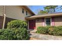 Home featuring a classic red front door and well-maintained landscaping at 2886 Thornbriar Rd, Atlanta, GA 30340