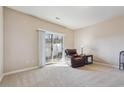 Carpeted living room with a sliding glass door to the outside at 3182 Mill Springs Cir, Buford, GA 30519