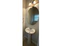 Powder room features a pedestal sink, decorative lighting, and a large mirror at 6941 Rogers Pt, Lithonia, GA 30058