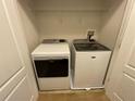 Laundry closet with side-by-side washer and dryer, and white wire shelving at 6941 Rogers Pt, Lithonia, GA 30058