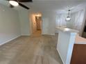 Open concept living room with neutral carpet and fresh paint offering natural light at 6941 Rogers Pt, Lithonia, GA 30058