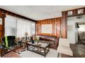 Cozy living room with wood paneled walls, large window, and comfortable seating at 2293 Ewing Sw St, Atlanta, GA 30331