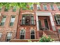 Detailed view of brick townhomes, showcasing the front entrances, windows, and balcony details at 2548 Crescent Park Ct # 7, Atlanta, GA 30339