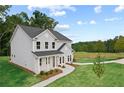Lovely two-story home with gray siding, a covered porch, and well-maintained landscaping at 410 Beacon Way Way, Villa Rica, GA 30180
