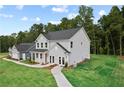 Lovely home showcasing gray siding, a lush green lawn, mature trees, and a connecting two-car garage at 410 Beacon Way Way, Villa Rica, GA 30180