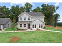 Beautiful two-story home with a well-manicured lawn, classic gray siding, and a welcoming entrance at 410 Beacon Way Way, Villa Rica, GA 30180