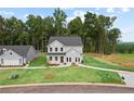 Beautifully landscaped home featuring classic gray siding, a lush green lawn, and mature trees at 410 Beacon Way Way, Villa Rica, GA 30180
