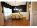 Elegant dining room with wainscoting, modern lighting, and ample seating at 8145 Lakeview Pkwy, Villa Rica, GA 30180