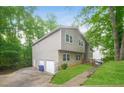Well-maintained home with siding, stone accents, two-car garage and a neatly kept lawn at 8607 Wood Springs Ct, Douglasville, GA 30135