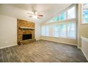 Bright living room featuring a stone fireplace, hardwood floors, and large windows at 8607 Wood Springs Ct, Douglasville, GA 30135