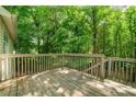 Exterior of the wood back deck surrounded by lush green trees providing shade at 503 Fable Ln, Canton, GA 30114