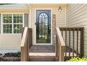 Inviting front entrance with a decorative door and welcoming sign on wood porch at 503 Fable Ln, Canton, GA 30114