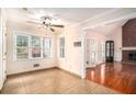 Sun-drenched sun room with tiled floor, leading into Gathering room with fireplace and gleaming hardwood floor at 5633 Southland Dr, Stone Mountain, GA 30087