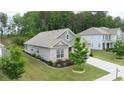 Charming one-story home with brick accents, well-manicured lawn, and a concrete driveway at 7570 Rambling Vale, Cumming, GA 30028