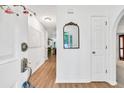 Inviting entryway featuring hardwood floors, a decorative mirror, and access to other rooms in the home at 2101 Emerald Dr, Loganville, GA 30052