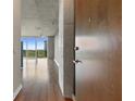 Modern apartment entryway with hardwood floors, concrete accents, and city view at 3300 Windy Ridge Se Pkwy # 1107, Atlanta, GA 30339