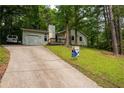 Inviting single Gathering home featuring a charming front porch and lush, mature landscaping at 3963 Ferncliff Rd, Snellville, GA 30039