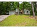 Inviting single Gathering home featuring a charming front porch and lush, mature landscaping at 3963 Ferncliff Rd, Snellville, GA 30039