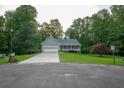 Inviting single-story home features a well-kept lawn, a two-car garage, and classic curb appeal at 399 Towler Drs, Loganville, GA 30052