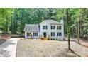 Lovely two-story home with black shutters, a charming porch, and a spacious front lawn at 545 Woodrow Dr, Lawrenceville, GA 30043