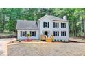 Beautiful two-story home with black shutters, a cozy porch, and a well-maintained lawn at 545 Woodrow Dr, Lawrenceville, GA 30043