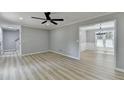 Open-concept living area showcasing light wood floors and an archway leading to the dining room at 545 Woodrow Dr, Lawrenceville, GA 30043