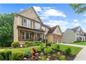 Charming home with a front porch, beautiful landscaping and a lush green lawn at 155 Edgewater Trl, Canton, GA 30115
