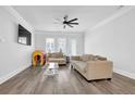 Bright living room featuring modern furniture, a ceiling fan, and plenty of natural light at 2139 Kirkham Way, Kennesaw, GA 30152