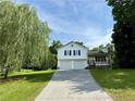 Charming two-story home featuring a front porch, two-car garage, and a long driveway at 23 Jennifer Ln, Rydal, GA 30171