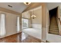 Open living room with staircase, light-colored carpet, and large windows for natural light at 3865 Portico Run Dr, Buford, GA 30519