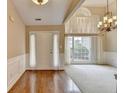 Bright living room featuring hardwood floors, a vaulted ceiling, and a chandelier at 3865 Portico Run Dr, Buford, GA 30519