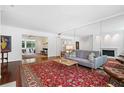 Spacious living room with hardwood floors, mirror, and a vibrant red patterned rug at 52 Chaumont Nw Sq, Atlanta, GA 30327
