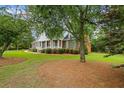 Beautiful brick home with covered front porch and meticulously maintained lawn at 1253 Oakwood Pl, Loganville, GA 30052