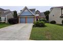 Charming two-story home with a well-manicured lawn and an attached two-car garage at 13030 Crabapple Lake Dr, Roswell, GA 30076