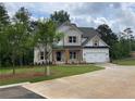 Beautiful two-story home featuring a brick and white exterior and a spacious two car garage at 2021 Shallowford Rd, Marietta, GA 30066