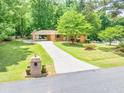 Inviting exterior view of this brick home, showing the circular driveway and mature trees at 519 Beaver Ruin Nw Way, Lilburn, GA 30047