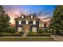 Charming two-story home with manicured lawn and elegant architectural details at dusk at 6815 Berkley Rd, Cumming, GA 30040