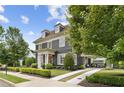 Charming two-story home with landscaped yard and elegant architectural details with a porte-cochère at 6815 Berkley Rd, Cumming, GA 30040