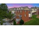 Exterior evening shot of brick townhomes with bay windows and attached garages at 2207 Concordia Se Way # 12, Mableton, GA 30126