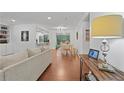 Open-concept living area featuring wood floors, a sofa, dining table and view to the kitchen at 2808 Vinings Central Se Dr, Atlanta, GA 30339