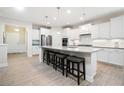 Bright and spacious kitchen features a large island, stainless steel appliances, and white cabinetry at 215 Windsor Park Dr, Woodstock, GA 30188