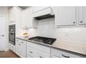 Well-equipped kitchen featuring granite countertops, stainless steel appliances, and ample cabinet space at 215 Windsor Park Dr, Woodstock, GA 30188
