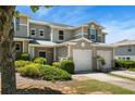 Inviting townhome showcasing a one-car garage, lush greenery, and a well-manicured lawn at 554 Rendevous Rd, Acworth, GA 30102