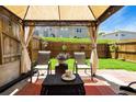 Cozy outdoor patio with a gazebo, comfortable seating, and a charming privacy fence at 554 Rendevous Rd, Acworth, GA 30102