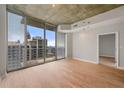 Modern living room with large windows offering a city view and stylish lighting fixtures at 855 Peachtree Ne St # 3205, Atlanta, GA 30308