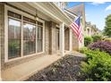 Inviting front porch with an American flag at 1839 Tranquil Field Nw Dr, Acworth, GA 30102