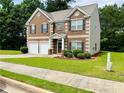 Charming two-story brick home with well-manicured lawn and a two-car garage at 5848 Rex Ridge Loop, Rex, GA 30273